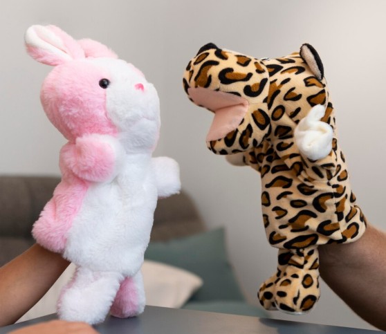 Rabbit and tiger hand puppets facing each other.
